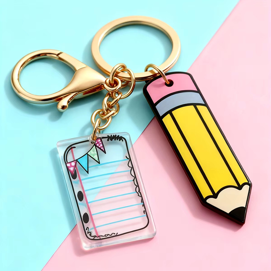 Buchförmiger Schlüsselanhänger aus Kunststoff als Taschenanhänger und Stifthalter in Multicolour - Bild 1