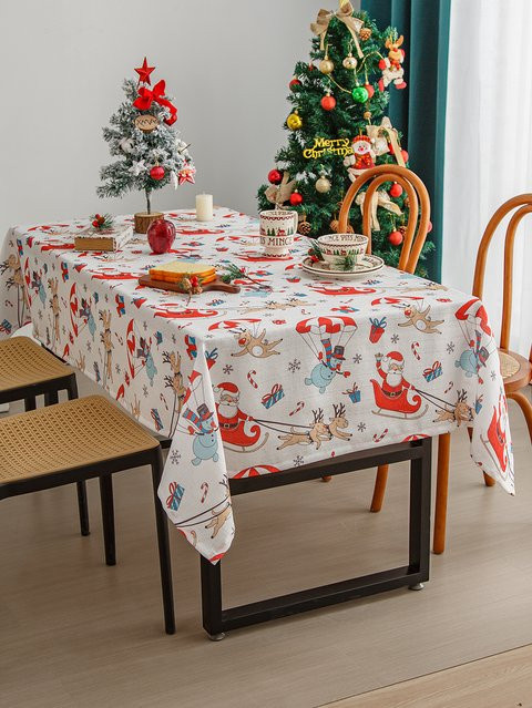 Waschbare Weihnachts-Tischdecke aus Leinen in Rot und Weiß mit Winter-Motiven wie Schneemann, Haus und Bäumen - Bild 1