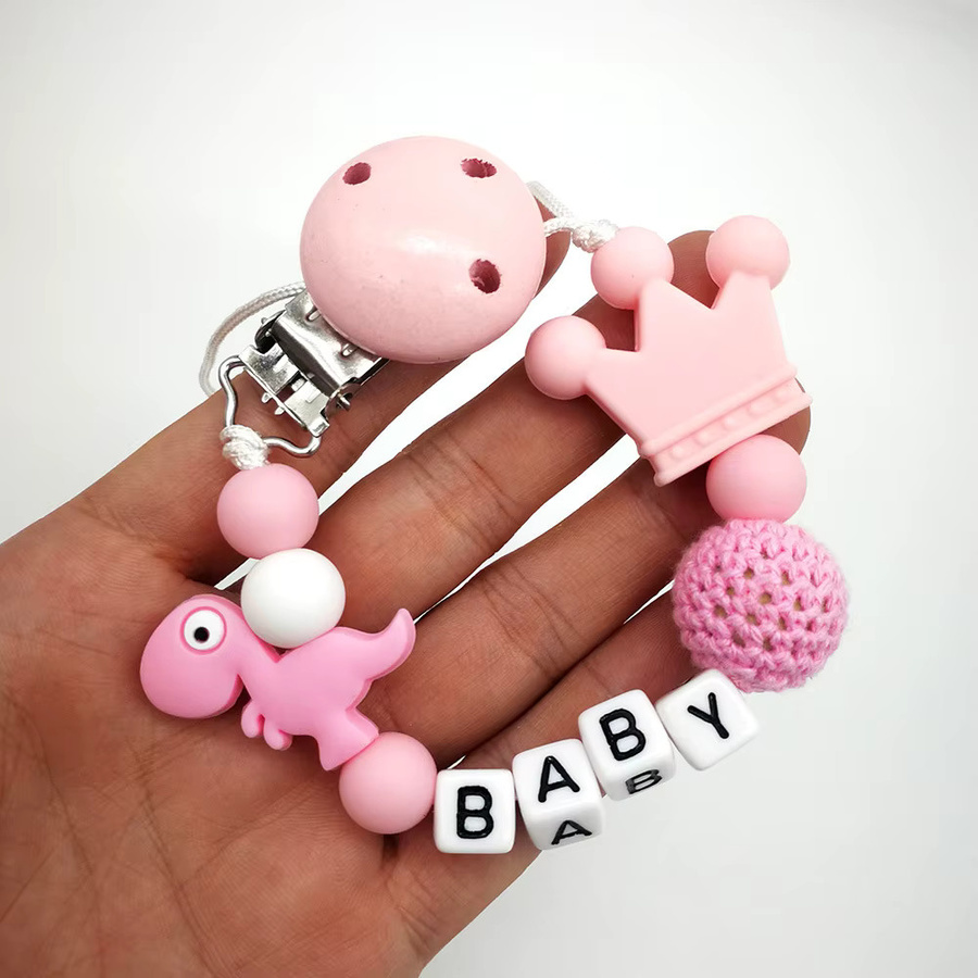 Panplay Schnullerkette aus Holz mit Dinosaurier-Motiv in Bunt für dein Baby - Bild 2