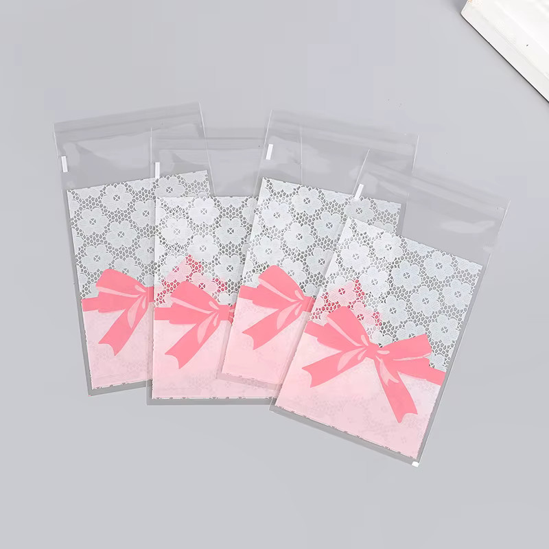 50 Stück Rosa Schleife und Blumen Motiv OPP Süßigkeiten Taschen Selbstdichtende Snack Verpackung für Geburtstag Hochzeit und Party - Bild 3