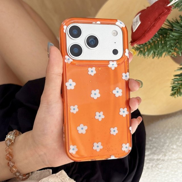 Stoßfeste Handyhülle für iPhone 17, 16, 15 und 14 Pro Max mit glänzendem orangefarbenem Hintergrund und weißen Blumenmustern - Bild 1