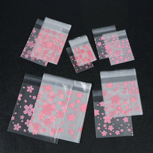 100 Stück transparente selbstklebende Verpackungsbeutel mit Kirschblüten-Motiv von Linsoir Beads für DIY-Schmuck, Backwaren und Kekse - Bild 1