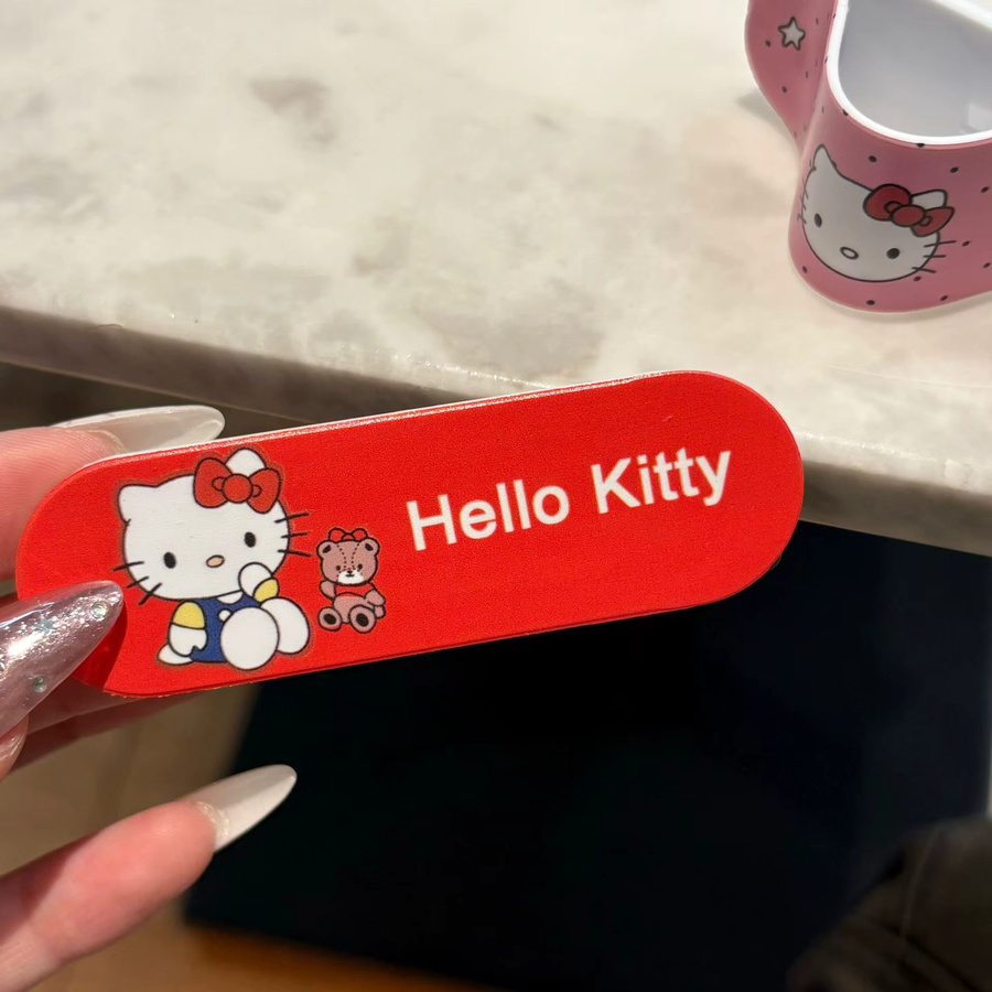 Sanrio Hello Kitty Handyhalterung im Pflaster-Design als universeller Push-Pull-Ständer für dein Smartphone - Bild 2