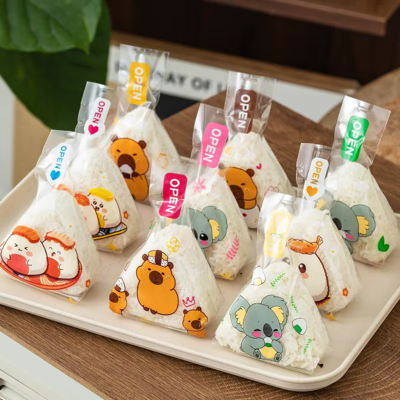 50 oder 100 Stück transparente Dreieck Onigiri Sushi Taschen mit Cartoon Capybara Motiv aus Kunststoff für Bento und Reisbälle - Bild 2