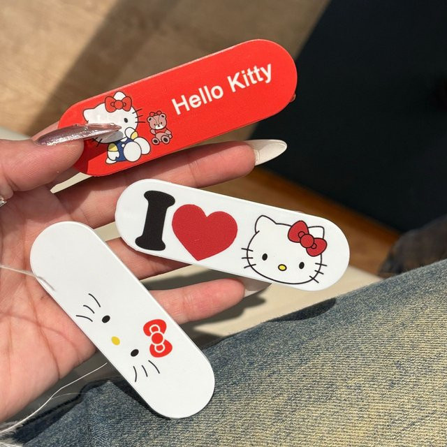 Sanrio Hello Kitty Handyhalterung im Pflaster-Design als universeller Push-Pull-Ständer für dein Smartphone - Bild 1