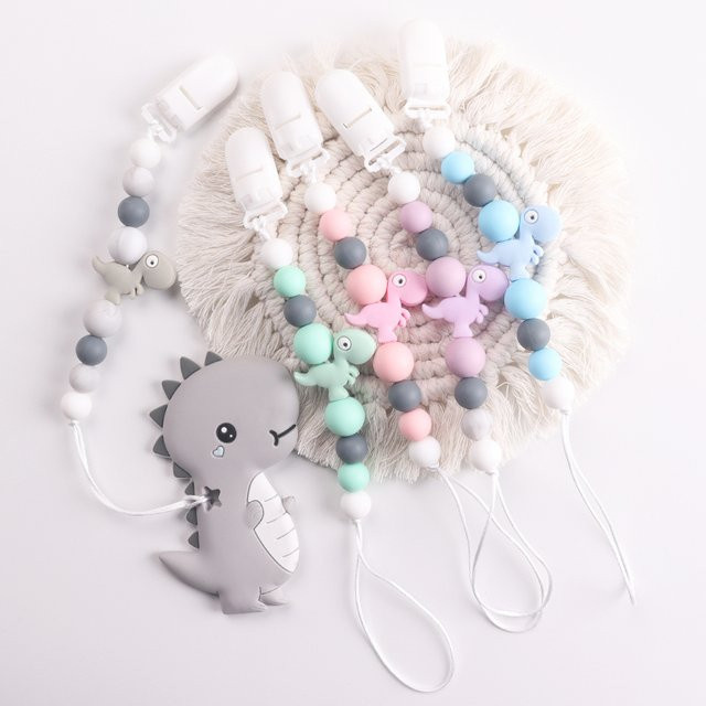 Set aus 4 oder 5 Baby Dinosaurier Silikon Schnullerketten mit Beißring und Anhänger in Gelb und Bunt, BPA-frei - Bild 1