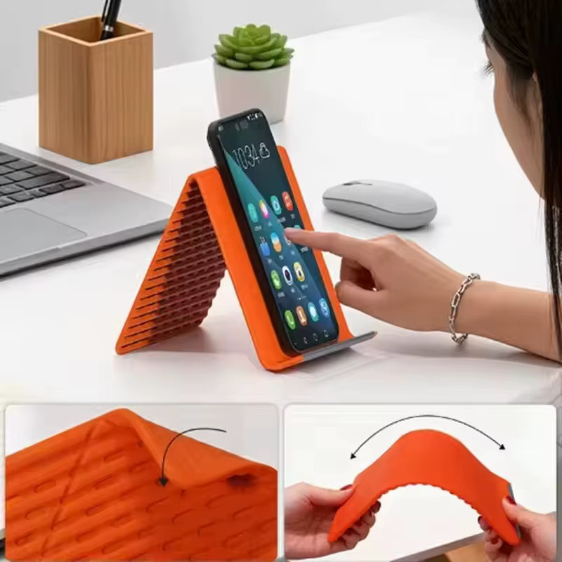 Universeller faltbarer und flexibler Silikon-Handyständer in Schwarz oder Orange, mehrfach winkelverstellbarer und biegbarer Tischhalter für dein Smartphone - Bild 3