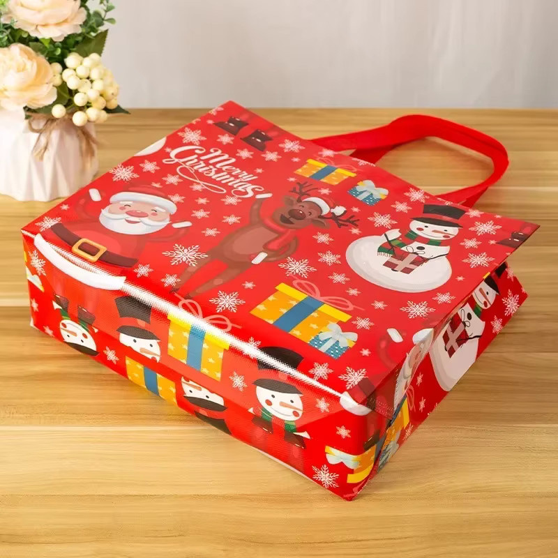 Weihnachtsgeschenktüten aus Vliesstoff mit laminiertem Griff in Blau und Rot, B/H: 32 x 10 cm - Bild 1