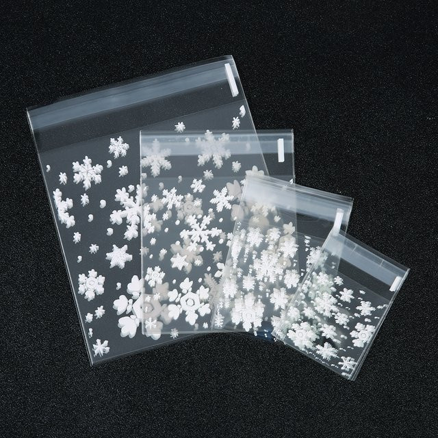 100 Stück transparente OPP Plastiktüten mit Schneeflocken-Design für Weihnachten, selbstklebende wiederverschließbare Beutel für Schmuck und Süßigkeiten - Bild 1