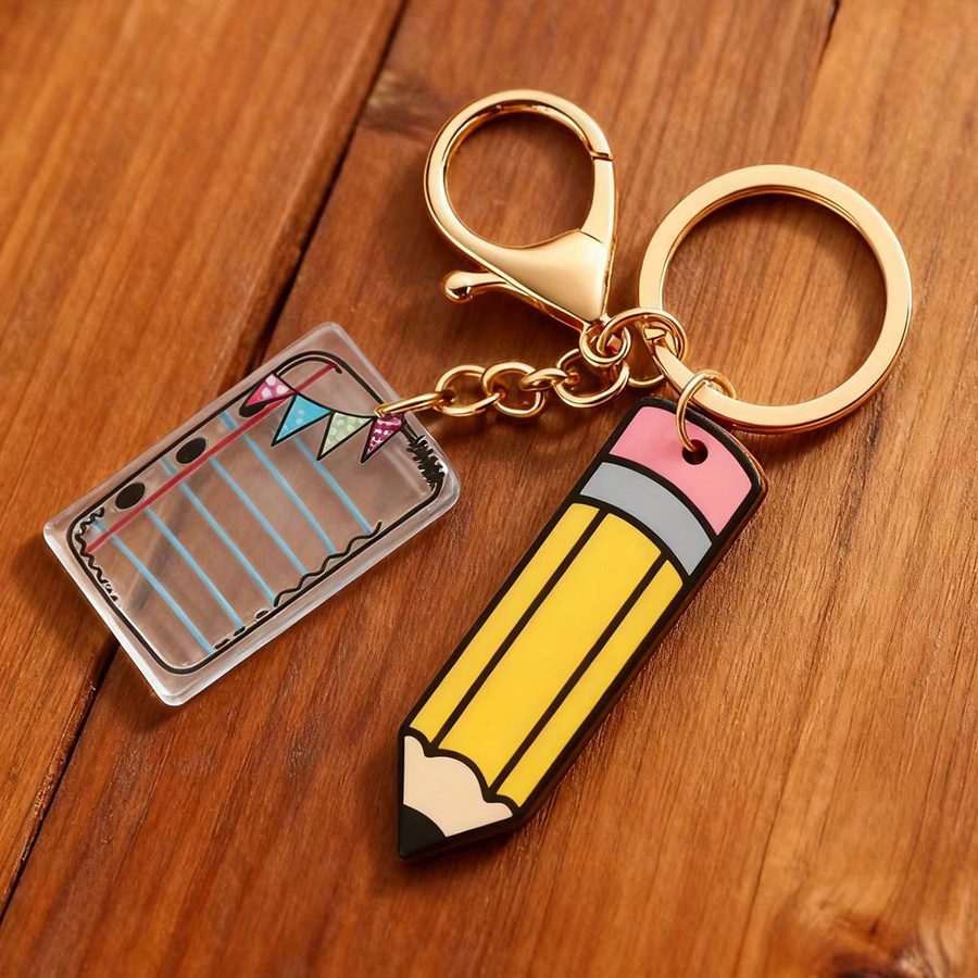 Buchförmiger Schlüsselanhänger aus Kunststoff als Taschenanhänger und Stifthalter in Multicolour - Bild 2