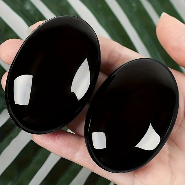 Polierter Obsidiankristall in Schwarz als ovaler Palmenstein für Yoga und Meditation - Bild 1