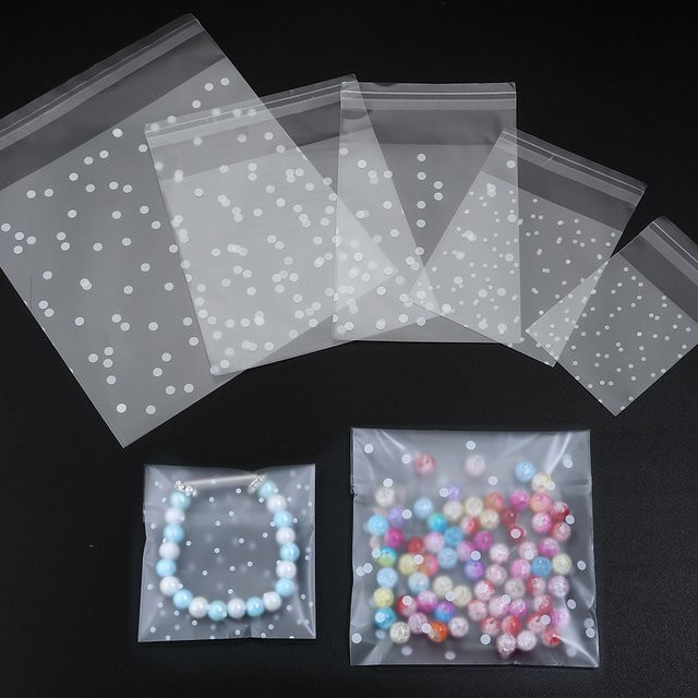 100 Stück Selbstdichtende Geschenkbeutel mit weißem Polka Dot Muster, Transparente Frosted Verpackungstaschen für Schmuck und Cookies, Weiß/Transparent - Bild 1