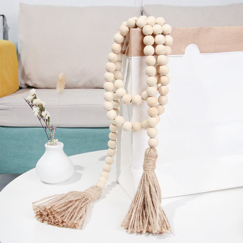 Handgefertigte Boho-Girlande aus Holzperlen und Jute-Quasten in Beige zur Wanddekoration - Bild 1