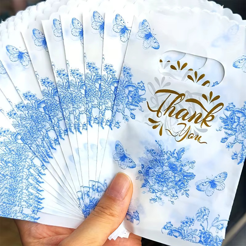 Blaue Geschenktüten aus Papier mit Schmetterlingsdruck und Blumenmuster für besondere Anlässe und Partys - Bild 2
