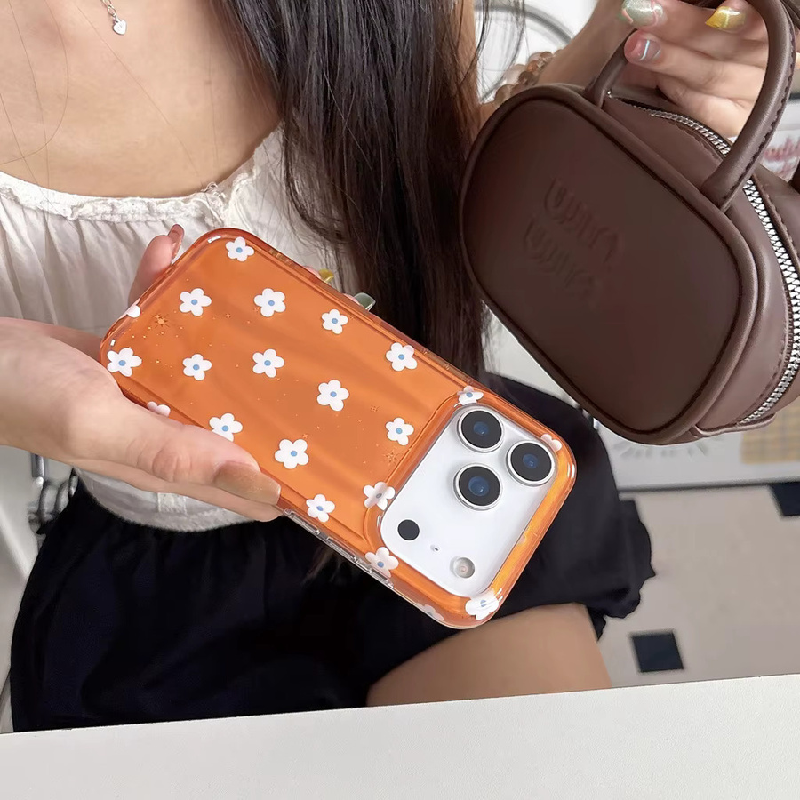 Stoßfeste Handyhülle für iPhone 17, 16, 15 und 14 Pro Max mit glänzendem orangefarbenem Hintergrund und weißen Blumenmustern - Bild 4