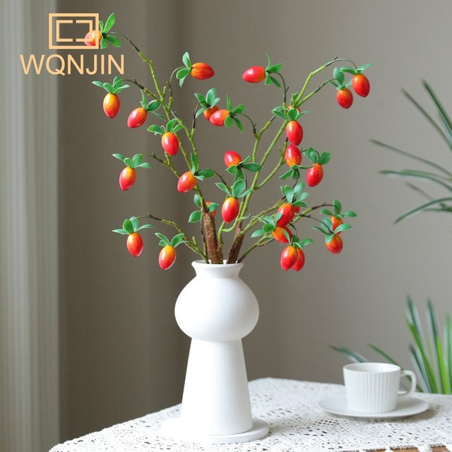 Künstlicher Granatapfelzweig mit Blättern von WQNJIN in Rot und Orange zur Dekoration für dein Zuhause oder den Garten - Bild 1