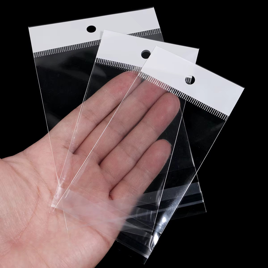 50 Stück selbstklebende OPP-Verpackungsbeutel aus Kunststoff mit weißer Karte und Loch für Schmuck und Geschenke von filluck, transparent - Bild 4