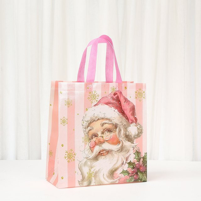 Tragbare Weihnachtsgeschenktüten aus Vliesstoff in Pink mit Weihnachtsmann-Griff für Weihnachten und Neujahr - Bild 1