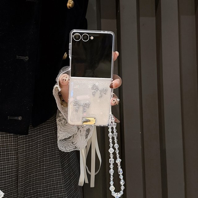 Transparente Koreanische Glitter Handyhülle mit Bogen-Design und Kette für Samsung Galaxy Z Flip 7, Z Flip 6 und Z Flip 5 in Beige - Bild 1
