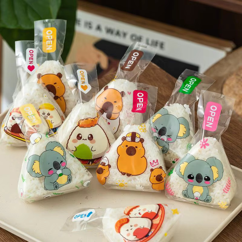 50 oder 100 Stück transparente Dreieck Onigiri Sushi Taschen mit Cartoon Capybara Motiv aus Kunststoff für Bento und Reisbälle - Bild 4
