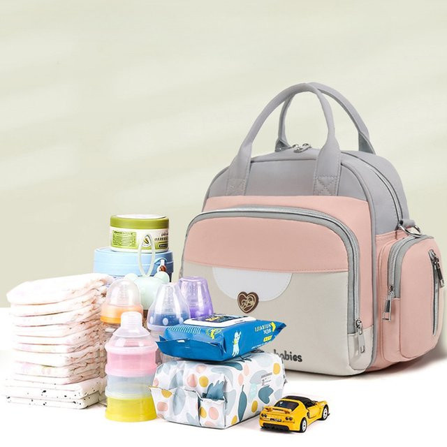 Wasserdichte und leichte Wickeltasche als Rucksack in Pink für Babys und Neugeborene - Bild 1