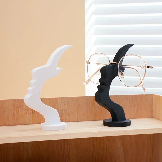 Minimalistischer Brillenhalter mit seitlichem Gesicht von DUTRIEUX aus Kunststoff in Schwarz oder Weiß für den Schreibtisch oder Nachttisch - Bild 1