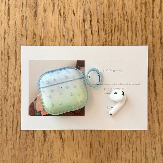 Transparente Kopfhörer-Schutzhülle für Apple AirPods 1, 2, 3, 4 und Pro/Pro 2 mit blau-grünem Farbverlauf und Blumenmuster - Bild 1