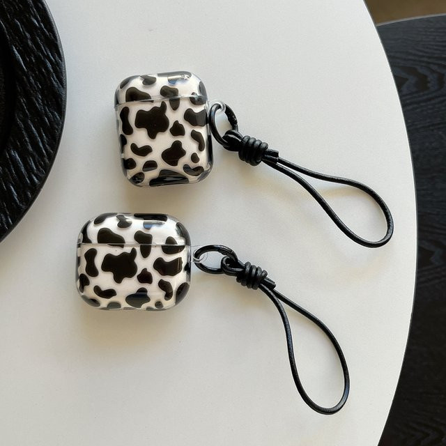 Leder-Lanyard Kopfhörerhülle mit Kuhmuster für Apple AirPods 1, 2, 3, 4 und Pro in Schwarz-Weiß - Bild 1