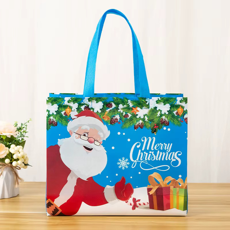 Wasserdichte Weihnachtsgeschenktüten aus Vliesstoff mit Weihnachtsmann Elch und Schneeflocken Motiv in Blau - Bild 2