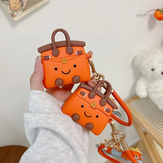 Sanrio Silikon-Handtaschen-Etui mit Anhänger für Apple AirPods Pro 1. und 2. Generation, Farbe: Orange - Bild 1