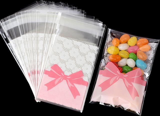 50 Stück Rosa Schleife und Blumen Motiv OPP Süßigkeiten Taschen Selbstdichtende Snack Verpackung für Geburtstag Hochzeit und Party - Bild 1