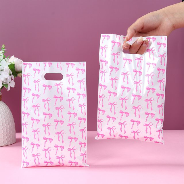 Huiran Geschenkverpackungstaschen aus Kunststoff mit rosa Schleife für Süßigkeiten, Kuchen und Snacks, ideal für Geburtstag, Hochzeit oder Babyparty, Farbe: Rosa - Bild 1
